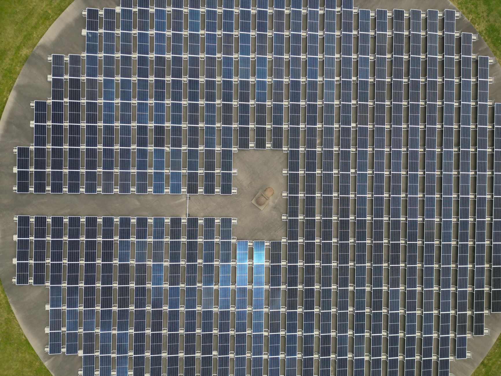 Solar panels and a battery storage unit installed beside a rural home